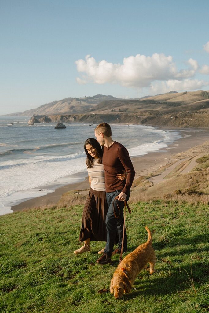Couple standing beside the California coastline on the Sonoma Coast