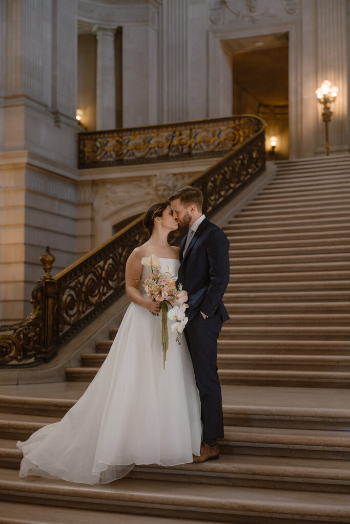 Couple sharing a kiss after their San Francisco City Hall Rotunda elopement ceremony. 