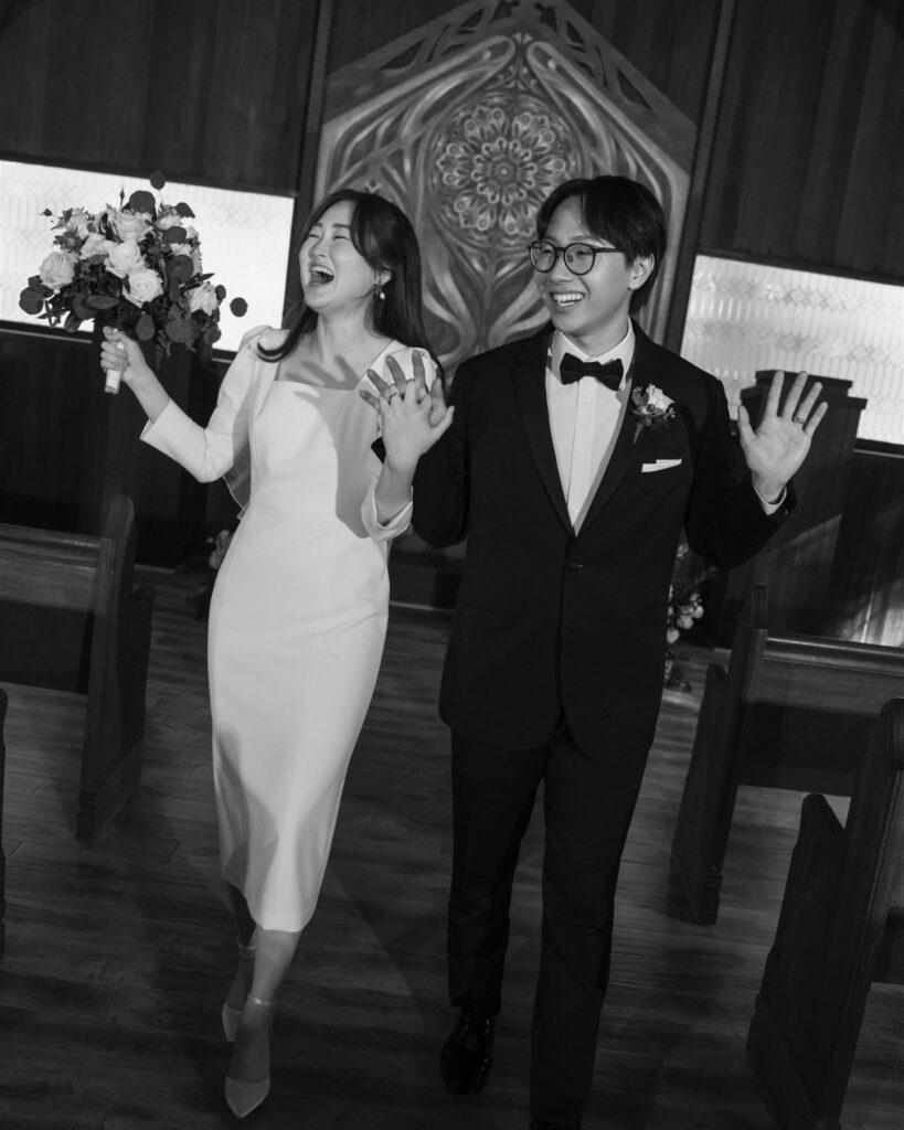 Newly married couple celebrating their ceremony exit at one of the most beautiful intimate wedding venues San Francisco Bay Area has for small weddings.
