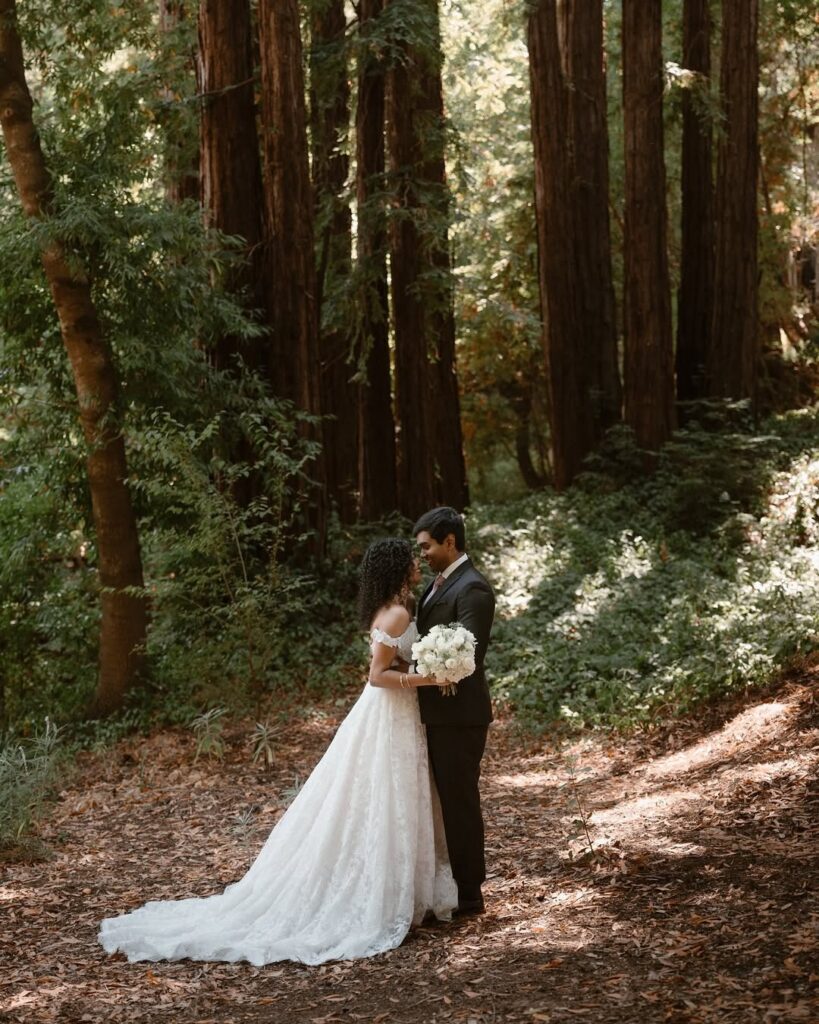 Couple sharing a quiet moment beneath towering redwoods at one of the most beautiful San Francisco small wedding venues.