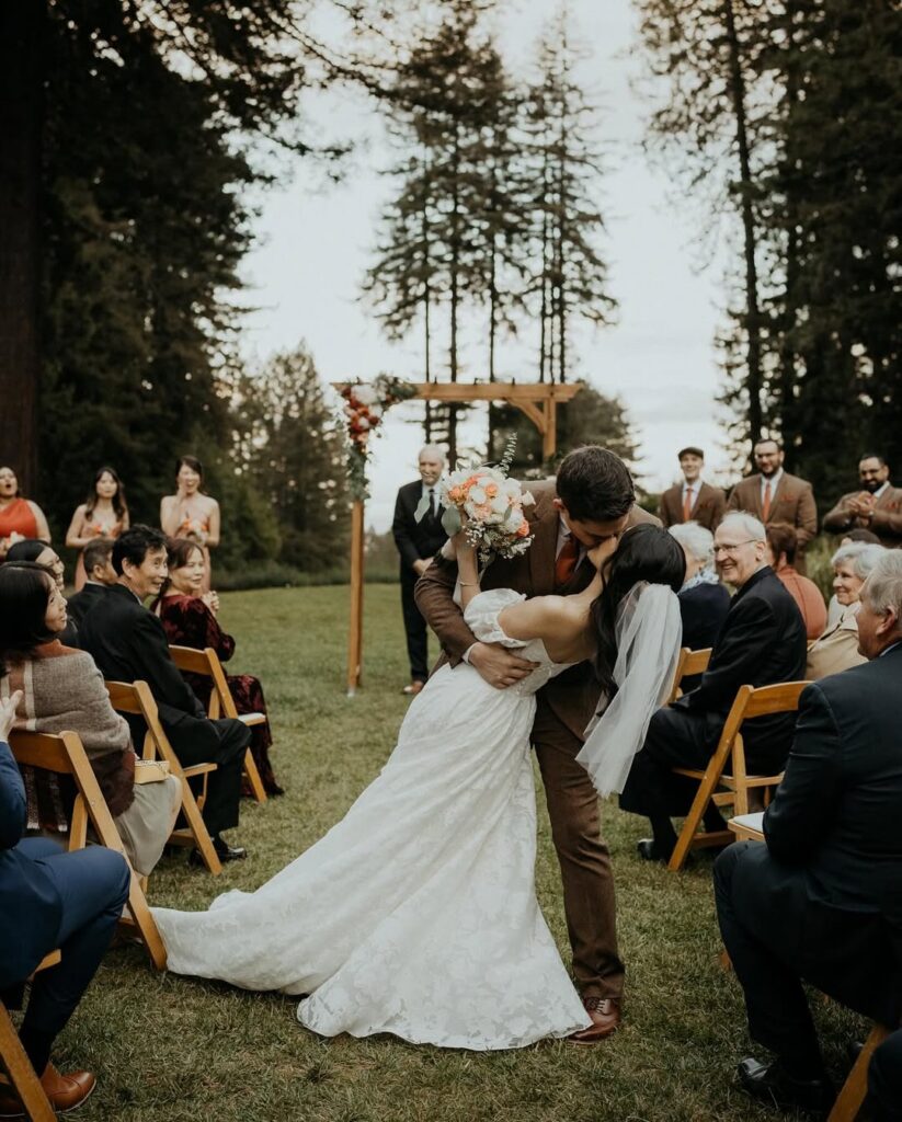 Bride and groom celebrating their first kiss at one of the most beautiful small wedding venues San Francisco has for outdoor ceremonies.