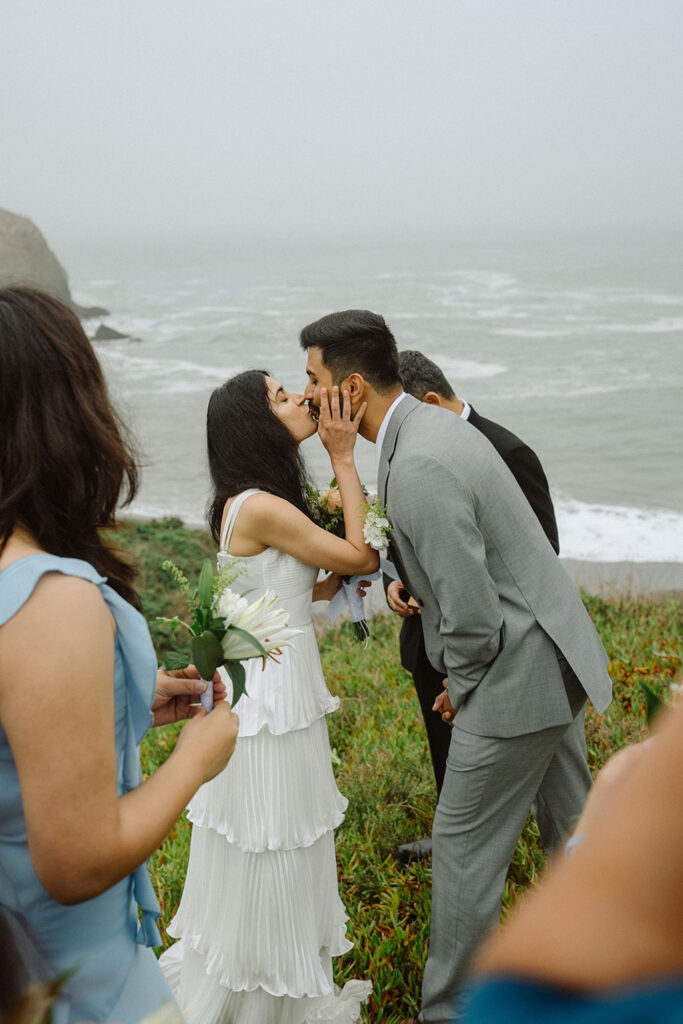 Couple kissing at their intimate wedding ceremony in Northern California, at Marin Headlands