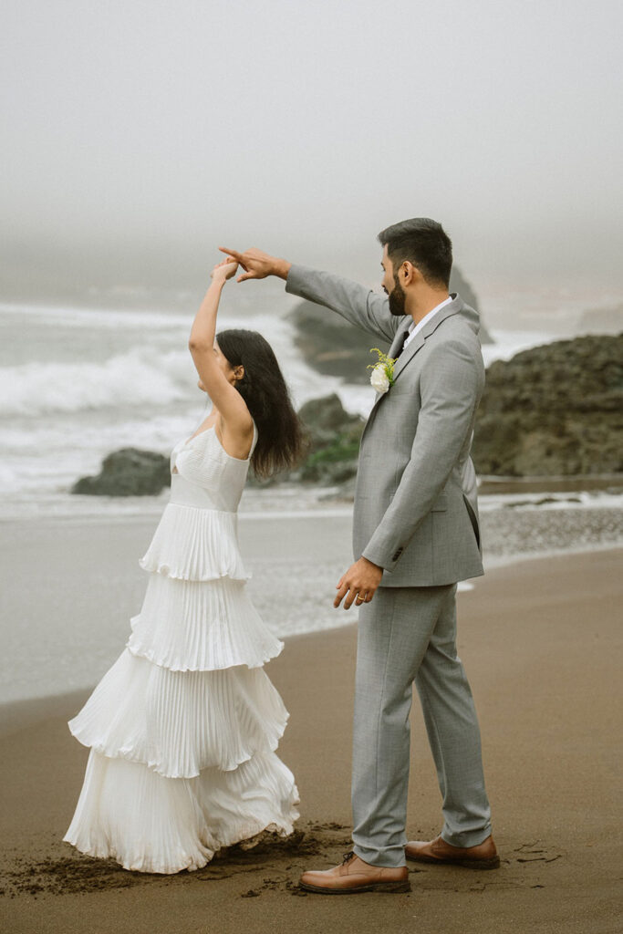 Couple dancing on the beach at Marin Headlands for their intimate wedding