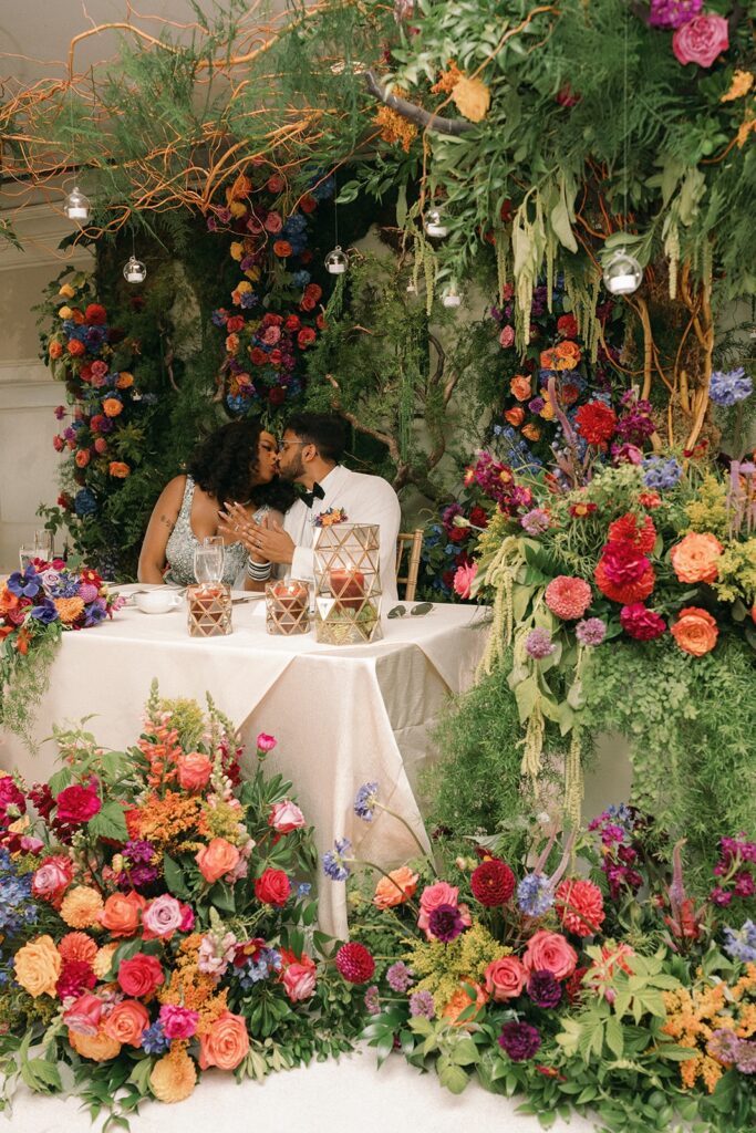 An Indian and Cameroonian couple share a kiss at their Seattle wedding venue