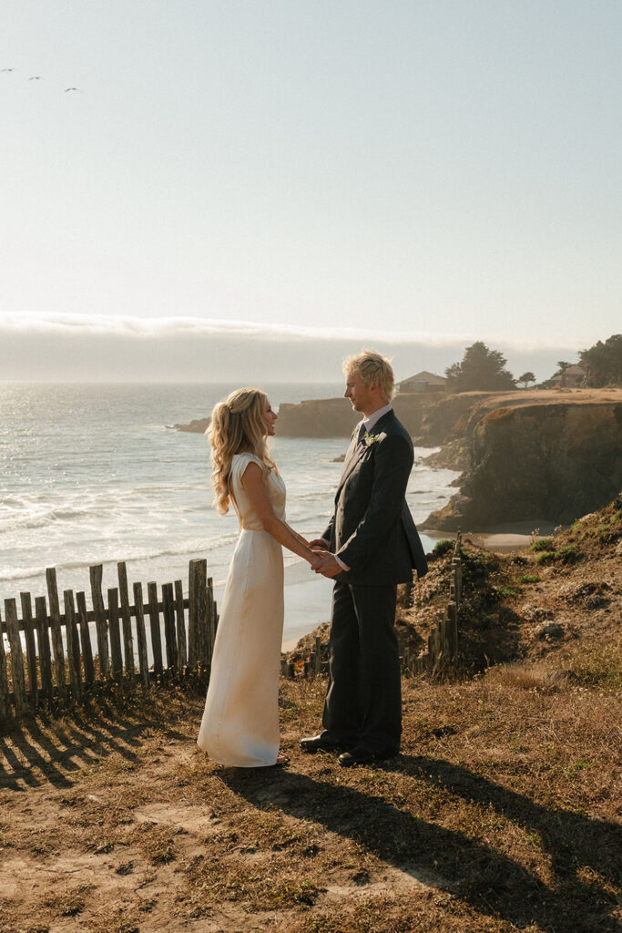 Couple holding hands at Sea Ranch intimate wedding venue