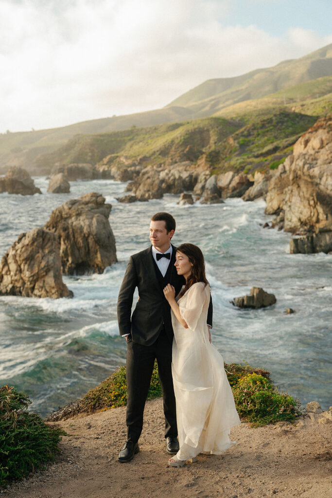 Bride and groom embracing on their wedding day at their intimate cliffside wedding in Big Sur